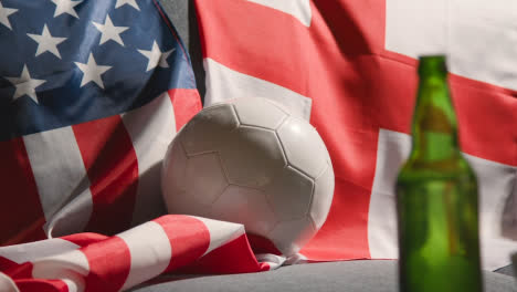 Sofa-In-Lounge-With-English-And-American-Flags-And-Ball-As-Fans-Watch-Football-Soccer-Match-On-TV-2