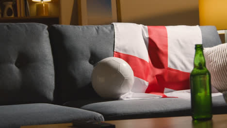 Sofa-In-Lounge-With-English-Flag-And-Ball-As-Fans-Prepare-To-Watch-Football-Soccer-Match-On-TV-3
