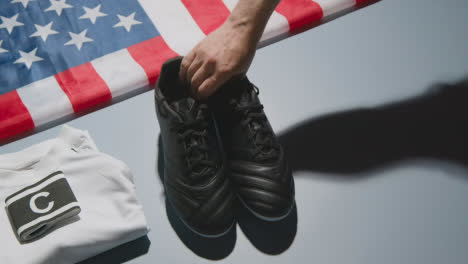 Studio-Still-Life-Shot-Of-Football-Soccer-Boots-American-Flag-Shirt-And-Shorts-And-Captains-Armband-1
