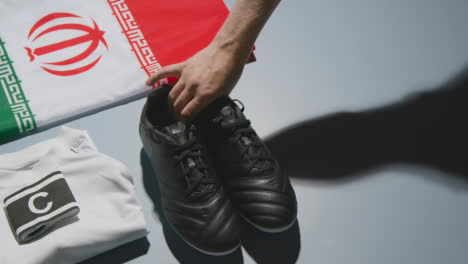 Studio-Still-Life-Shot-Of-Football-Soccer-Boots-Iranian-Flag-Shirt-And-Shorts-And-Captains-Armband-1