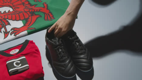 Studio-Still-Life-Shot-Of-Football-Soccer-Boots-Welsh-Flag-Shirt-And-Shorts-And-Captains-Armband-3