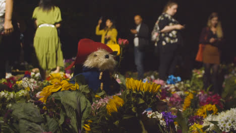 Close-Up-Shot-of-Floral-Tributes-and-Mourners-In-London's-Green-Park-03