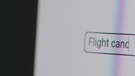 Close-Up-Of-Screen-With-Person-Typing-Flight-Cancellation-Compensation-Into-Computer-Search-Engine