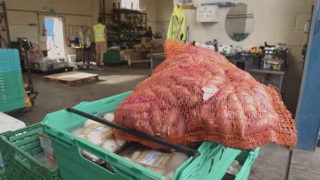 Interior-Of-UK-Food-Bank-Building-With-Fresh-Food-Being-Sorted-For-Delivery