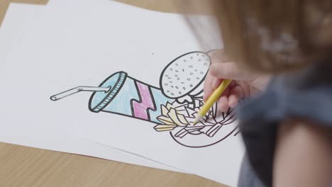 Close-Up-Of-Child-At-Home-Colouring-In-Picture-Of-Burger-Fries-And-Shake-At-Table-2