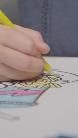 Vertical-Video-Close-Up-Of-Child-At-Home-Colouring-In-Picture-Of-Burger-Fries-And-Shake-At-Table-