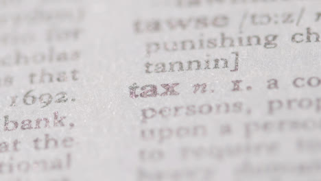Close-Up-On-Page-Of-Dictionary-With-Definition-Of-Word-Tax