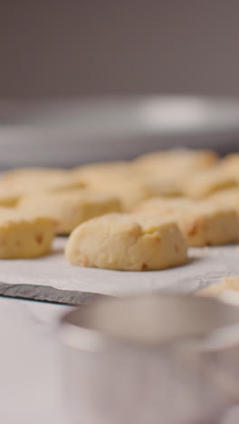 Vertikales-Video-Eines-Tabletts-Mit-Hausgemachten-Shortbread-Keksen-Auf-Der-Küchenarbeitsfläche-Mit-Zutaten