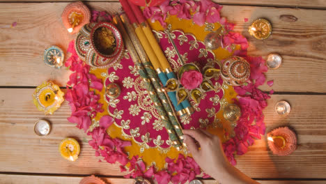 Overhead-Shot-Of-Person-Lighting-Lamps-Celebrating-Festival-Of-Diwali-In-Navratri-Scene