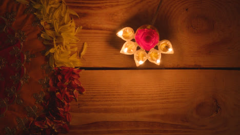 Person-Holding-Five-Wick-Lamp-On-Table-Decorated-To-Celebrate-Festival-Of-Diwali-1