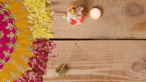 Overhead-Of-Table-Decorated-With-Statue-Of-Ganesh-And-Incense-For-Celebrating-Festival-Of-Diwali