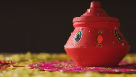 Traditional-Clay-Pot-With-Tea-Lights-On-Table-Decorated-For-Celebrating-Festival-Of-Diwali
