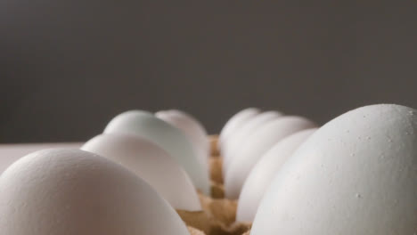 Close-Up-Studio-Shot-Of-Eggs-In-Cardboard-Carton-On-Kitchen-Worktop