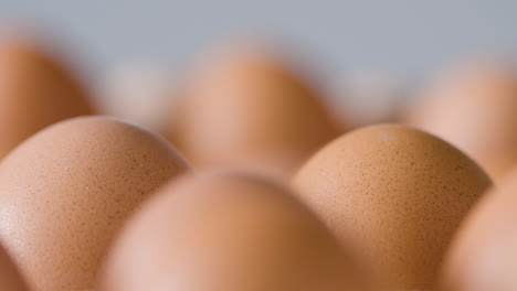 Close-Up-Studio-Shot-Of-Brown-Eggs-In-Cardboard-Tray