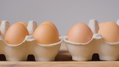 Studio-Shot-Of-Open-Cardboard-Egg-Boxes-Against-Grey-Background