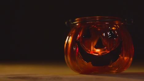 Halloween-Pumpkin-Jack-O-Lantern-With-Candle-Against-Black-Background