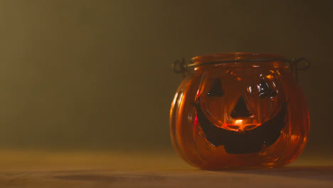 Halloween-Pumpkin-Jack-O-Lantern-With-Candle-Against-Black-Background-With-Smoke