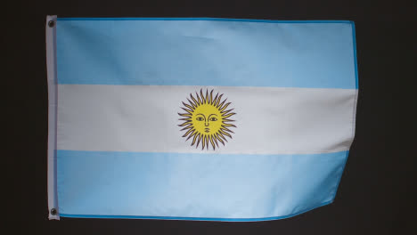 Studioaufnahme-Der-Flagge-Argentiniens-Vor-Schwarzem-Hintergrund