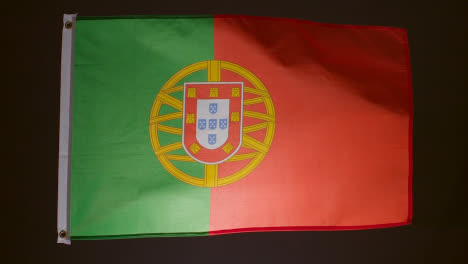 Studioaufnahme-Der-Portugiesischen-Flagge-Vor-Schwarzem-Hintergrund