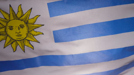 Close-Up-Studio-Shot-Of-Uruguayan-Flag-Flying-Filling-Frame
