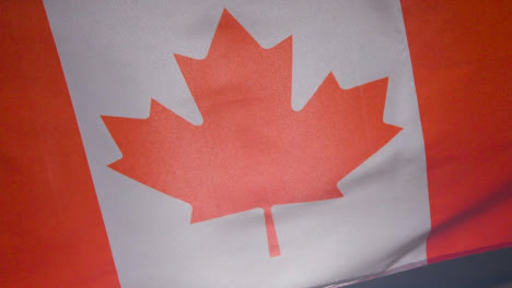 Close-Up-Studio-Shot-Of-Canadian-Flag-Flying-Filling-Frame