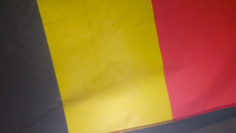 Close-Up-Studio-Shot-Of-Belgian-Flag-Flying-Filling-Frame
