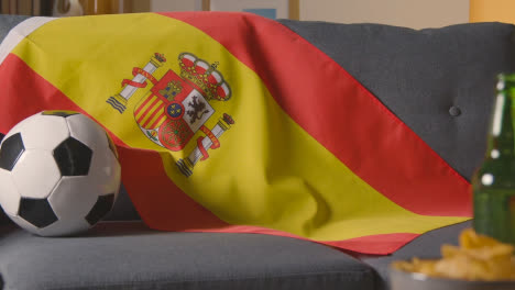 Flagge-Von-Spanien-über-Sofa-Zu-Hause-Drapiert-Mit-Fußball-Bereit-Für-Spiel-Im-Fernsehen-1