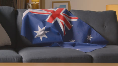 Flag-Of-Australia-Draped-Over-Sofa-At-Home-Ready-For-Match-On-TV