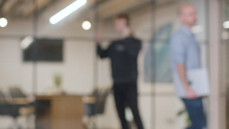 Defocused-Background-Shot-Of-Businessman-Working-Standing-In-Office-And-Talking-On-Phone