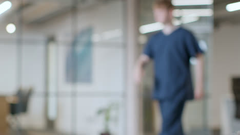 Defocused-Background-Shot-Of-Doctor-And-Nurse-In-Scrubs-Working-In-Hospital-