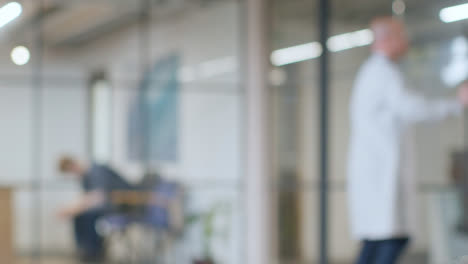 Defocused-Background-Shot-Of-Anxious-Patient-Waiting-In-Hospital-For-Appointment