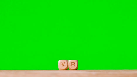 Business-Concept-Wooden-Letter-Cubes-Or-Dice-Spelling-VR-Against-Green-Screen
