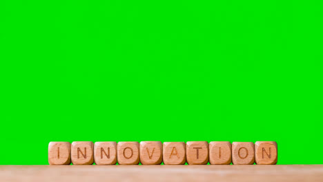 Business-Concept-Wooden-Letter-Cubes-Or-Dice-Spelling-Innovation-Against-Green-Screen