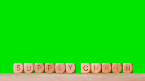 Business-Concept-Wooden-Letter-Cubes-Or-Dice-Spelling-Supply-Chain-Against-Green-Screen