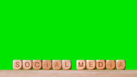 Business-Concept-Wooden-Letter-Cubes-Or-Dice-Spelling-Social-Media-Against-Green-Screen