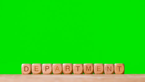 Education-Concept-With-Wooden-Letter-Cubes-Or-Dice-Spelling-Department-Against-Green-Screen-Background