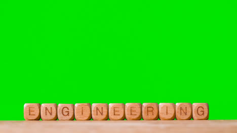 Education-Concept-With-Wooden-Letter-Cubes-Or-Dice-Spelling-Engineering-Against-Green-Screen