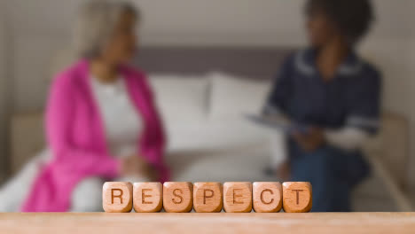 Concept-With-Wooden-Letter-Cubes-Or-Dice-Spelling-Respect-Against-Background-Of-Nurse-Talking-To-Patient-In-Hospital