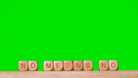 Concept-With-Wooden-Letter-Cubes-Or-Dice-Spelling-No-Means-No-Against-Green-Screen-Background
