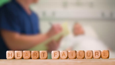 Medical-Concept-With-Wooden-Letter-Cubes-Or-Dice-Spelling-Heart-Failure-Against-Background-Of-Nurse-Talking-To-Patient-In-Hospital-Bed