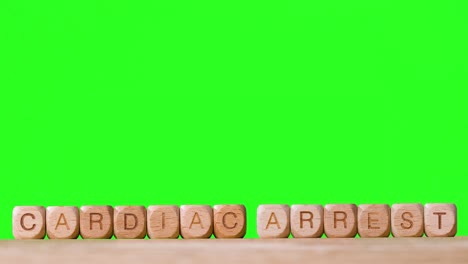 Medical-Concept-With-Wooden-Letter-Cubes-Or-Dice-Spelling-Heart-Attack-Against-Green-Screen-Background