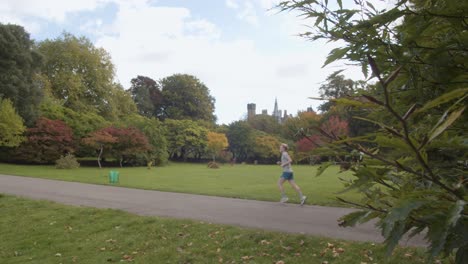 Autumn-View-Of-Bute-Park-In-Cardiff-Wales-With-Person-Running-Along-Path