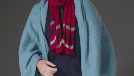 Close-Up-Of-Person-Wearing-Blanket-And-Scarf-Trying-To-Keep-Warm-In-Energy-Crisis