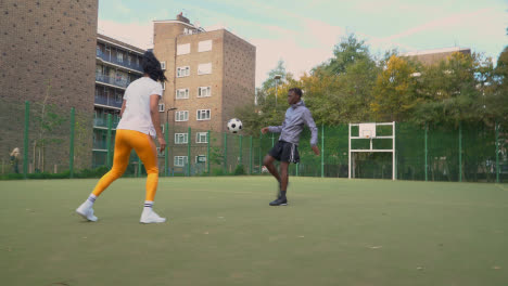 Spieler,-Die-Fußball-Auf-Einem-Künstlichen-Fußballplatz-Im-Städtischen-Stadtgebiet-Treten-Und-Weitergeben-5