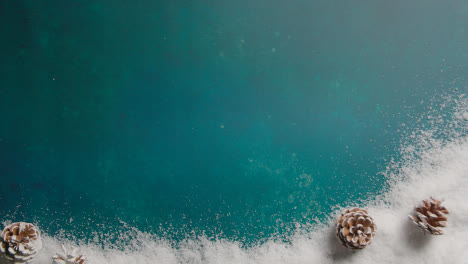 Overhead-Christmas-Background-With-Snow-And-Pine-Cones