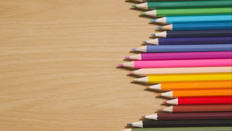 Coloured-Pencils-Geometrically-Arranged-In-A-Line-On-Wooden-Background-1