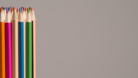 Studio-Shot-Of-Rotating-Multi-Coloured-Pencils-Against-Grey-Background-1