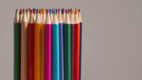 Studio-Shot-Of-Multi-Coloured-Pencils-Against-Grey-Background-