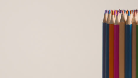 Studio-Shot-Of-Rotating-Multi-Coloured-Pencils-Against-White-Background-1