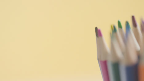 Studio-Shot-Of-Multi-Coloured-Pencils-Against-Yellow-Background-2